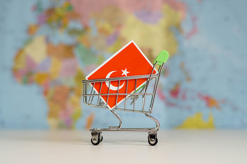 A photo of a toy shopping cart that has a Turkish flag in it